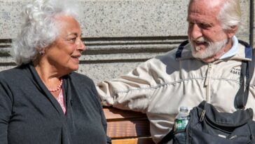 a man and a woman sitting on a bench
