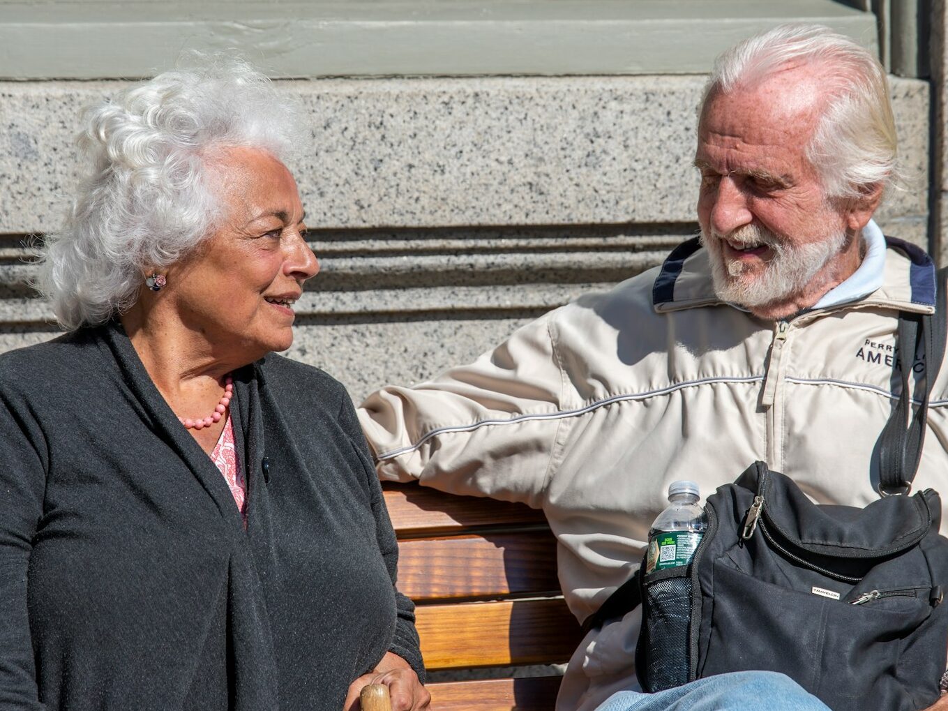 a man and a woman sitting on a bench
