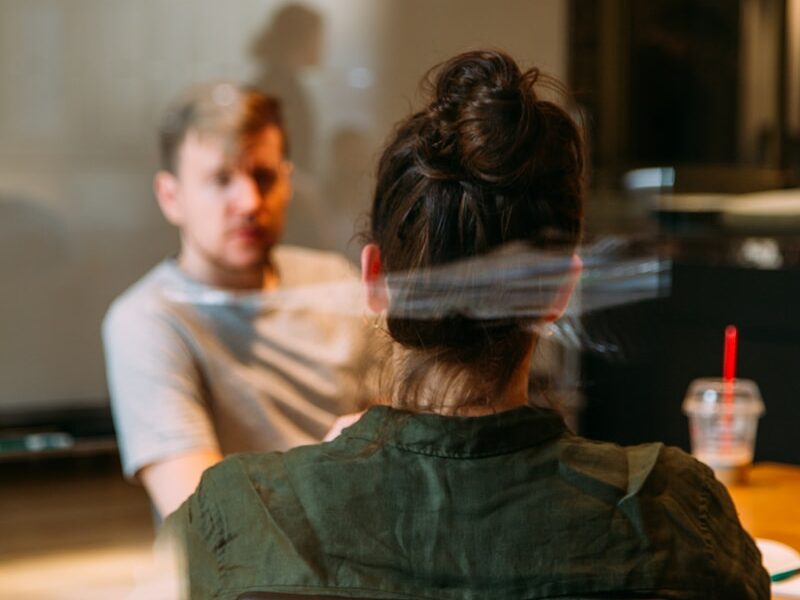 person sitting in a chair in front of a man
