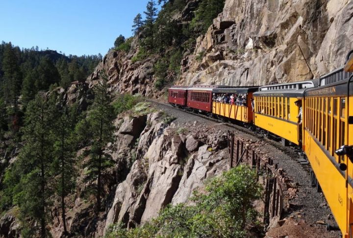 Riders Travel Along Cliff-Edge Tracks