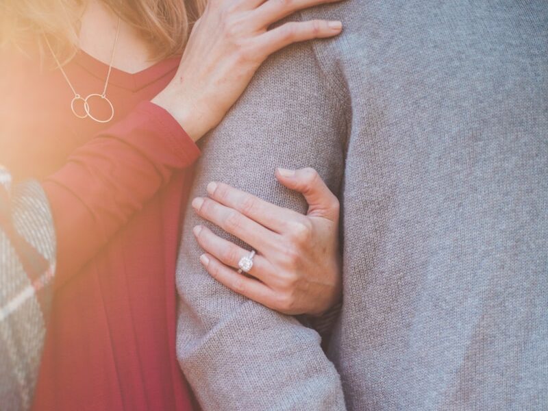 woman holding the shoulder of man