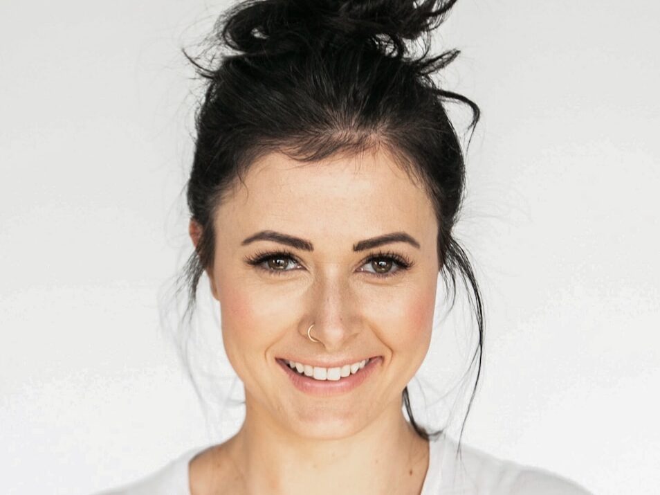 woman in white crew neck shirt smiling