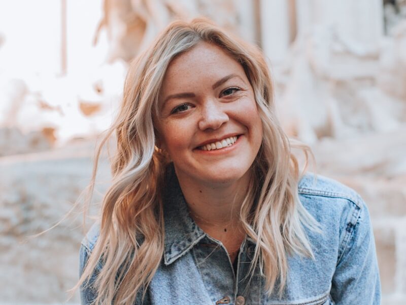 woman smiling wearing denim jacket