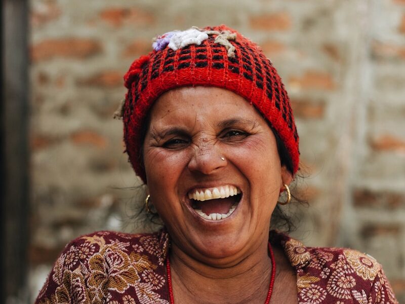 woman laughing while holding white roll