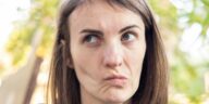 a close up of a person with a surprised look on their face
