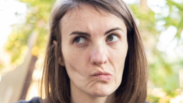 a close up of a person with a surprised look on their face