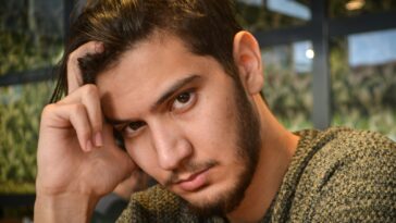 man in grey and black sweater