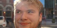 a close up of a person near a street