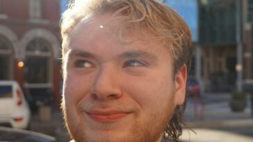 a close up of a person near a street